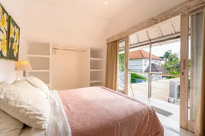 a bedroom with a bed and a large window at Villa Bella Vista by Pertama Management in Seminyak