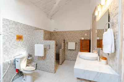 a bathroom with a sink and a toilet and a tub at Villa Bella Vista by Pertama Management in Seminyak