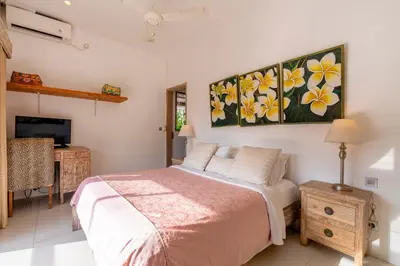 a bedroom with a bed and a painting on the wall at Villa Bella Vista by Pertama Management in Seminyak