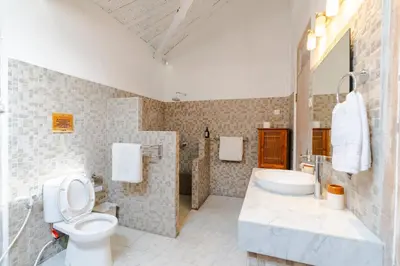 a bathroom with a toilet and a sink and a tub at Villa Bella Vista by Pertama Management in Seminyak