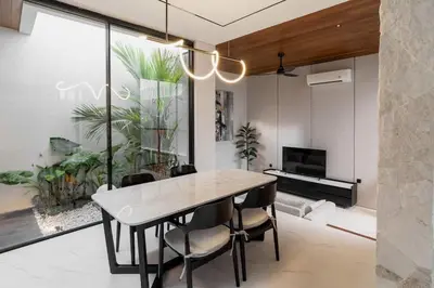 a dining room with a table and chairs and a piano at Luxury Haven Stunning 2Br in Umalas Canggu in Kerobokan