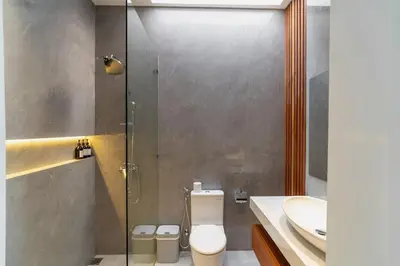 a bathroom with a shower and a toilet and a sink at Luxury Haven Stunning 2Br in Umalas Canggu in Kerobokan