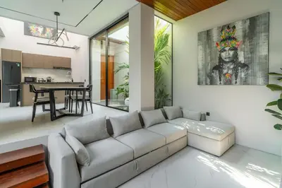 a living room with a couch and a kitchen at Luxury Haven Stunning 2Br in Umalas Canggu in Kerobokan