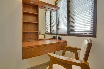 a room with a desk and a chair and a mirror at Villa Taman Seminyak 46 Near Double Six Beach in Seminyak