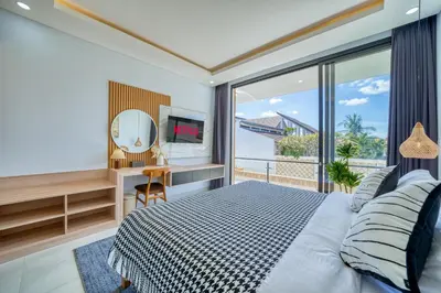 a bedroom with a bed and a desk with a mirror at Villa Kangla - 3BR Luxurious Villa Seminyak in Seminyak