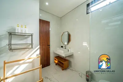 a bathroom with a sink and a mirror at SOHO Seminyak 1 - by Unicorn Villas Bali in Seminyak