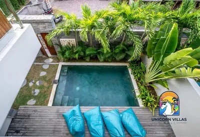 an overhead view of a swimming pool with blue pillows at SOHO Seminyak 1 - by Unicorn Villas Bali in Seminyak