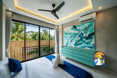 a bedroom with a large window with a view of the ocean at SOHO Seminyak 2 - by Unicorn Villas Bali in Seminyak