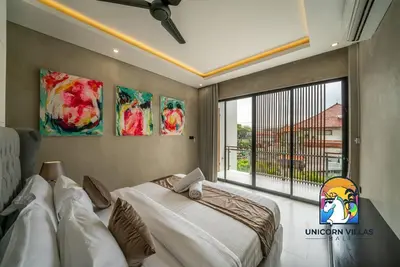 a bedroom with a bed and a large window at SOHO Seminyak 2 - by Unicorn Villas Bali in Seminyak