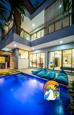 a large house with a swimming pool in front of it at SOHO Seminyak 2 - by Unicorn Villas Bali in Seminyak