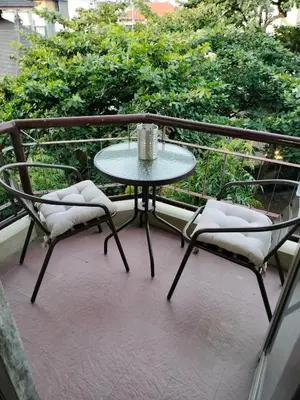 a table and two chairs on a balcony at Jayakarta Bali Apartment 6417 in Seminyak