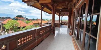 an outdoor balcony of a building with a view of the city at Kusuma Homestay Kerobokan in Kerobokan