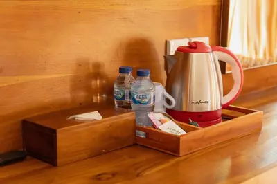 a wooden tray with two bottles of water and a blender at Dara House in Kuta