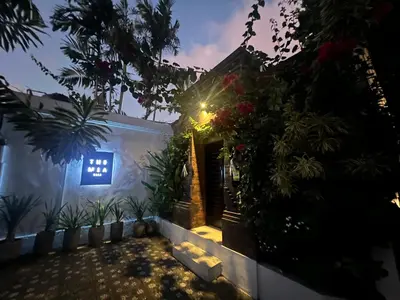 a house with a lit up door and plants at The Mia Bali in Kerobokan