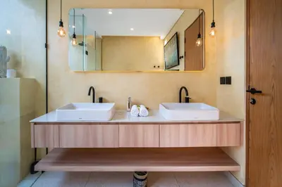 a bathroom with two sinks and a large mirror at Villa Casa Del Sol Umalas in Kerobokan