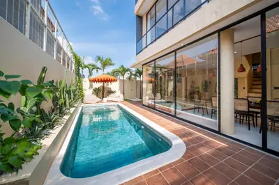 an indoor swimming pool in the backyard of a house at Villa Casa Del Sol Umalas in Kerobokan