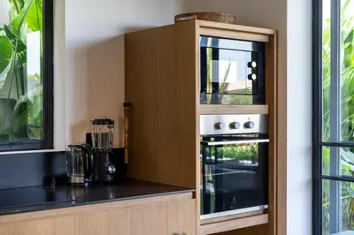 a kitchen with a stove and a counter top at Villa Charleston Umalas in Kerobokan