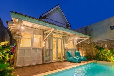 a villa with a swimming pool at night at SooBali Mint Cottage Sanur 1BR in Sanur