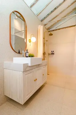 a bathroom with a white sink and a mirror at SooBali Mint Cottage Sanur 1BR in Sanur
