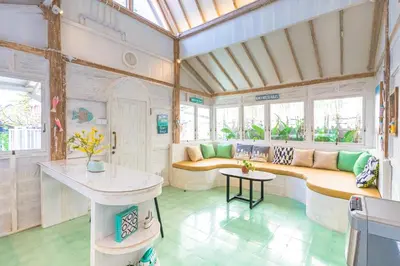 a living room with a couch and a table at SooBali Mint Cottage Sanur 1BR in Sanur