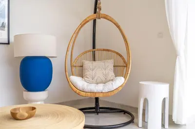a room with a rattan chair and a table at Kubung 2 - Perfect Retreat in Canggu in Kerobokan