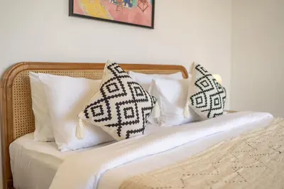 a bed with two pillows on top of it at Kubung 2 - Perfect Retreat in Canggu in Kerobokan