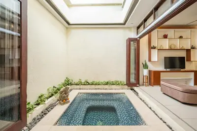 a swimming pool in the middle of a living room at Seven Residence in Seminyak