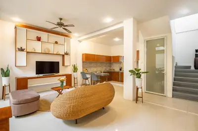 a living room with a couch and a television at Seven Residence in Seminyak
