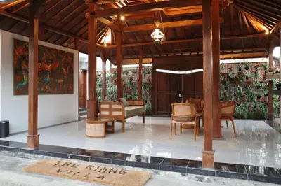 a pavilion with a table and chairs in a room at The Riang Villa in Kerobokan