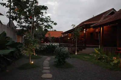 a courtyard of a house with a tree and a pathway at The Riang Villa in Kerobokan