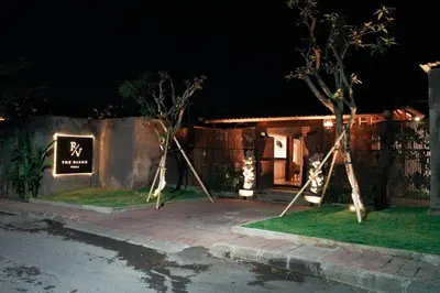 a sign in front of a house at night at The Riang Villa in Kerobokan
