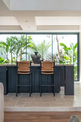 two chairs sitting at a counter in a room with windows at Villa Moana - Incredible 2BR Villa Next To The Beach in Canggu in Canggu
