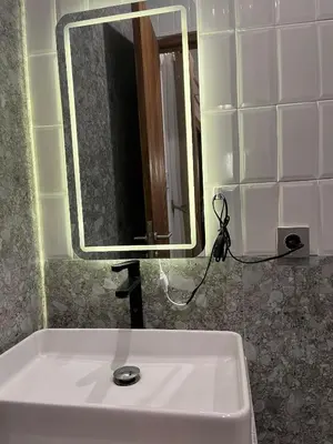 a bathroom with a white sink and a mirror at Della Rossa in Seminyak
