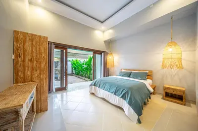 a bedroom with a bed and a large window at Q LO 1 , Seminyak in Seminyak