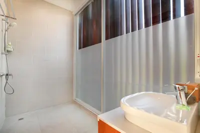 a bathroom with a shower and a sink at Villa Indaros in Seminyak