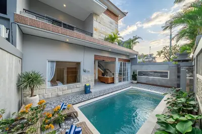 a swimming pool in the backyard of a house at Q LA Villas in Seminyak