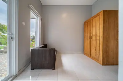 a room with a wooden door and a window at Q LA Villas in Seminyak