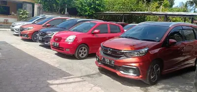a row of parked cars parked in a parking lot at Vico hotel in Nusa Dua