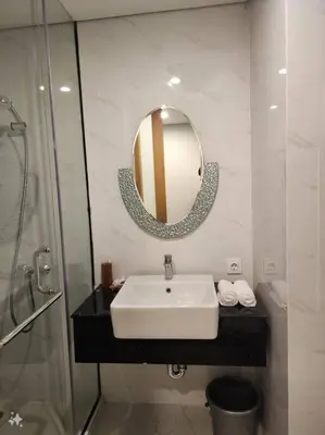 a bathroom with a sink and a mirror at de' Asasta Apartment Benoa E216 in Nusa Dua