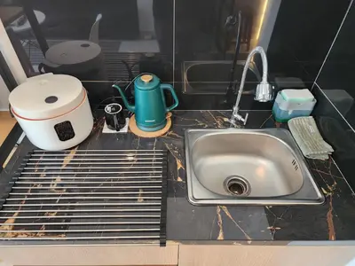 a kitchen counter with a sink and a toaster at de' Asasta Apartment Benoa E216 in Nusa Dua