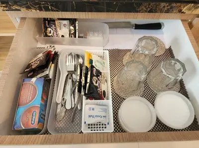 a drawer with utensils and other items in it at de' Asasta Apartment Benoa E216 in Nusa Dua