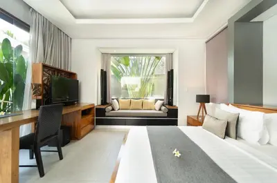 a hotel room with a bed and a television at The Black Pearl - The Best 1br Villa In Seminyak in Seminyak