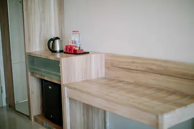 a wooden counter top in a room with a coffee maker at Mahogany Hotel in Nusa Dua