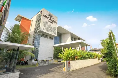 a building with a sign on the side of it at Mahogany Hotel in Nusa Dua
