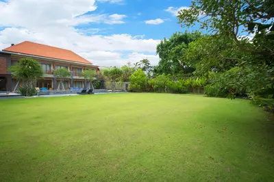 a large lawn in front of a house at Kubu Cempaka Seminyak in Seminyak