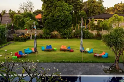 a group of chairs and tables in a yard at Kubu Cempaka Seminyak in Seminyak