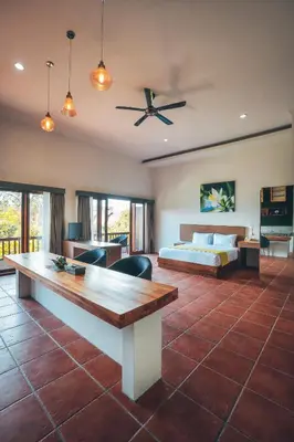 a living room with a bed and a table at Kubu Cempaka Seminyak in Seminyak