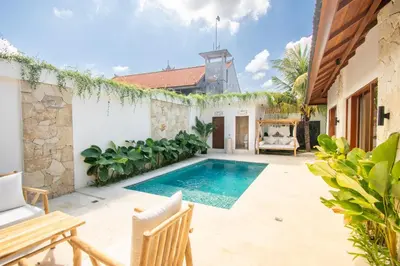 a swimming pool in the backyard of a house at Villa Mayo in Legian