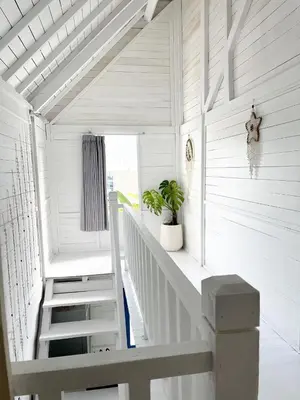 a white staircase in a house with a white ceiling at Kenzo hut3 mesari in Seminyak