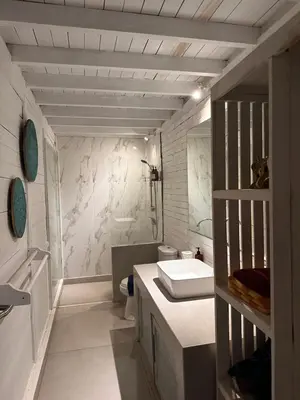a white bathroom with a sink and a toilet at Kenzo hut3 mesari in Seminyak